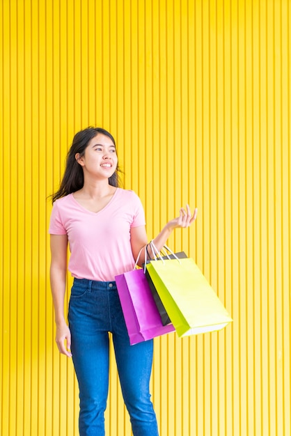 Asian woman holding shopping bags