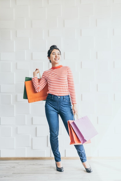 Asian woman holding shopping bags