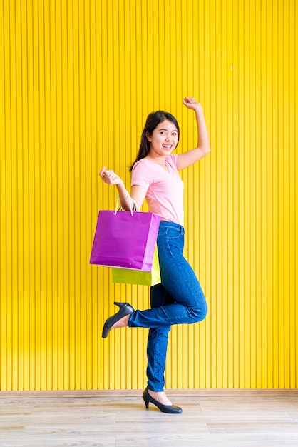 Asian woman holding shopping bags