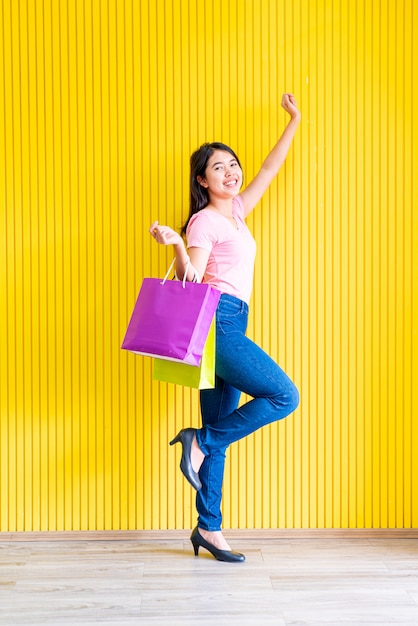 Asian woman holding shopping bags