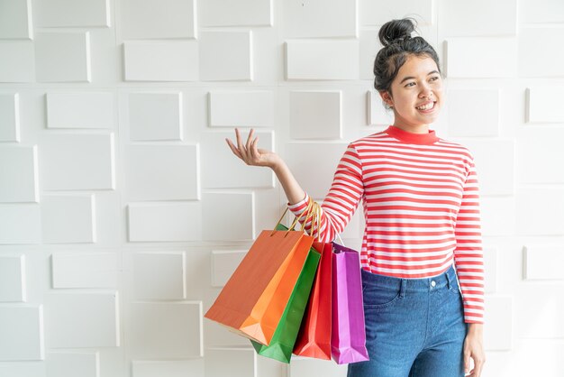 Asian woman holding shopping bags