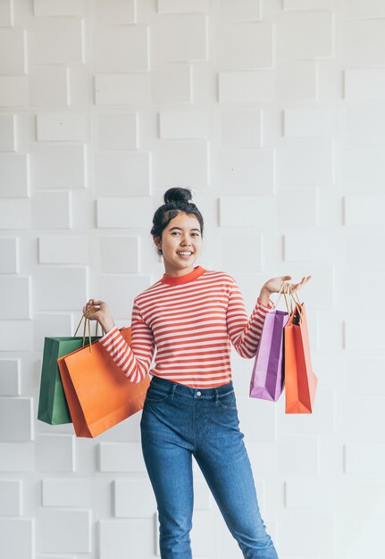 Asian woman holding shopping bags