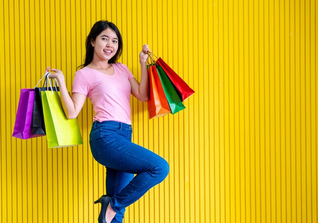 Asian woman holding shopping bags