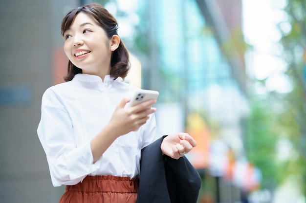 Asian woman holding a smart phone