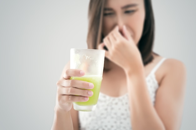 Asian woman holding a smelly garbage juice