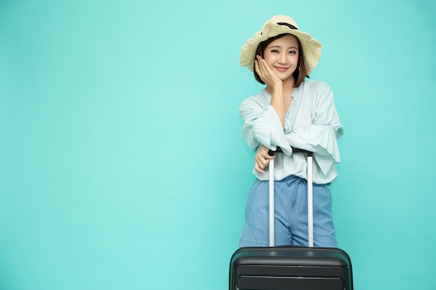 Asian woman holding suitcase isolated