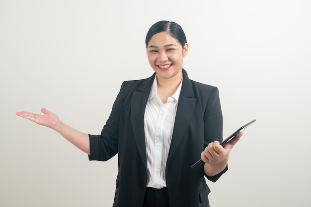 Asian woman holding and using tablet with white background