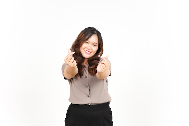 An Asian woman is showing the Korean love sign with a white background smiling brightly