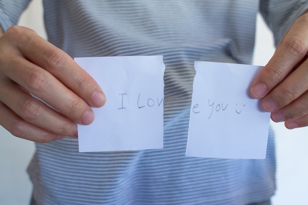 Asian woman is showing tear valentine's card 