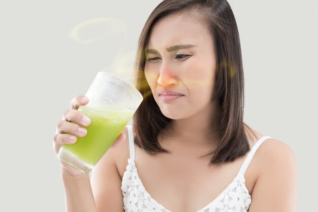 Asian woman is squeamish from the juice . Not delicious, Nasal congestion.