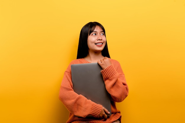 Asian woman and laptop and are happy to work Photo of a beautiful Asian woman who is happy working