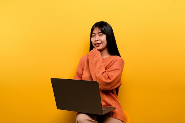 Asian woman and laptop and are happy to work Photo of a beautiful Asian woman who is happy working