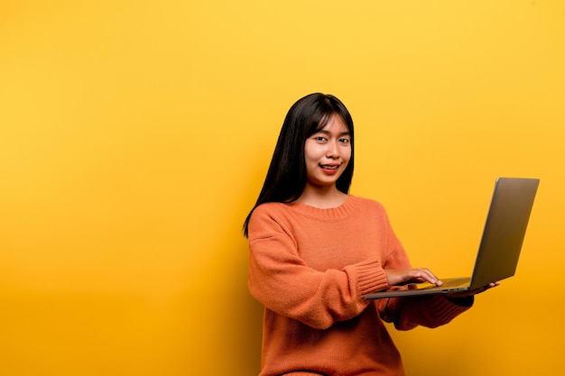 Asian woman and laptop and are happy to work Photo of a beautiful Asian woman who is happy working