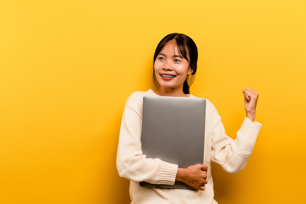 Asian woman and laptop and are happy to work Photo of a beautiful Asian woman who is happy working a