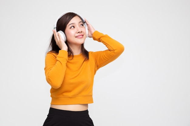 Asian woman listening music with headphones