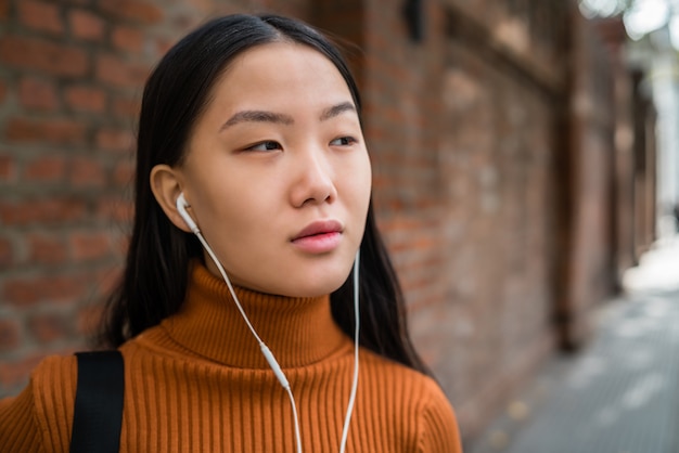 Asian woman listening music.