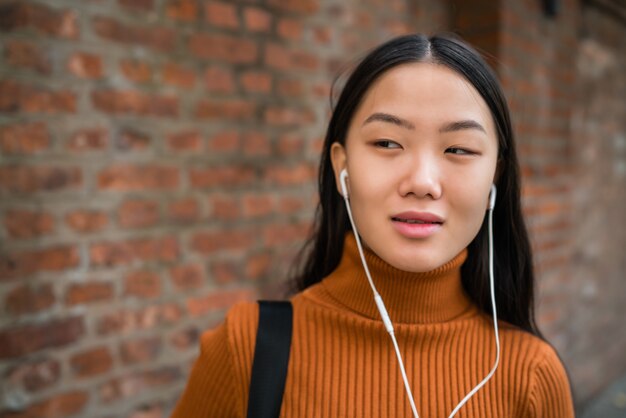 Asian woman listening music.