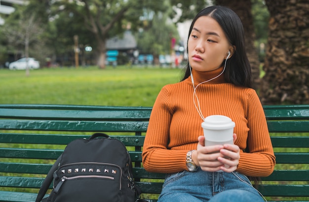 Asian woman listening to music