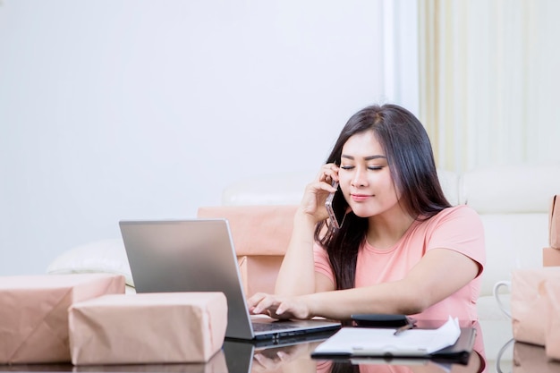 Asian woman listening something while working