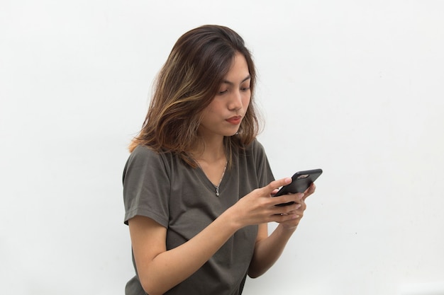 Asian woman looking at smart phone with feeling sad