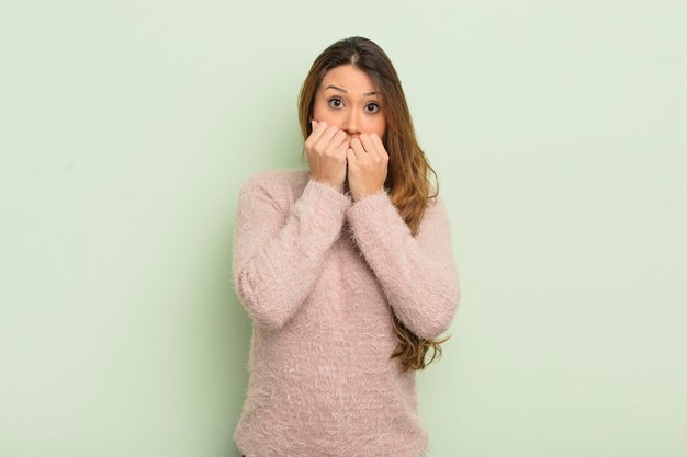 Asian woman looking worried anxious stressed and afraid biting fingernails and looking to lateral copy space