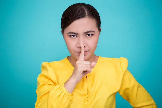 Photo asian woman make quiet sign