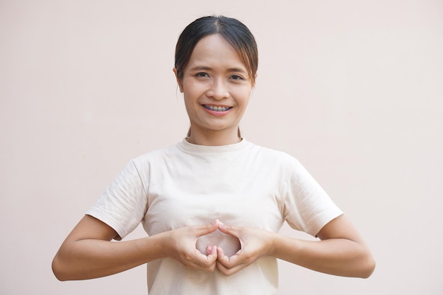 Asian woman making a heart with hands