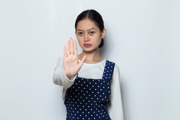 Asian woman making stop gesture with her hand