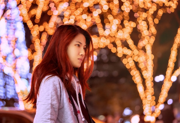 Asian woman outdoors in a cold evening