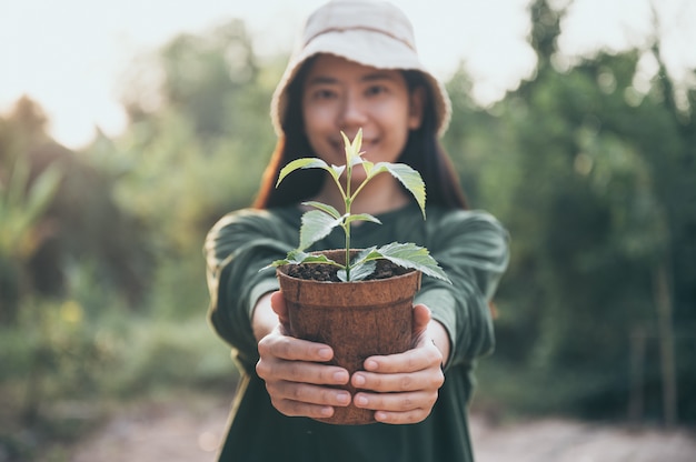 Asian woman planting trees for the environment