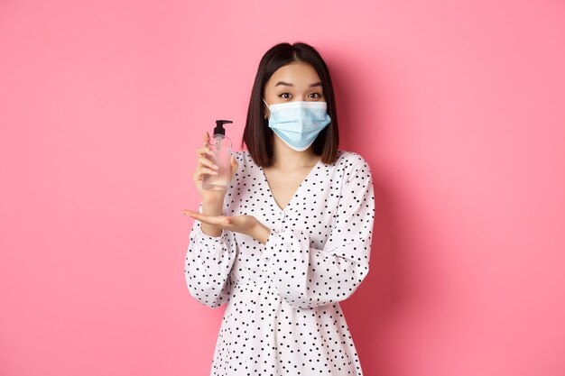 Asian woman pointing fingers at her face mask