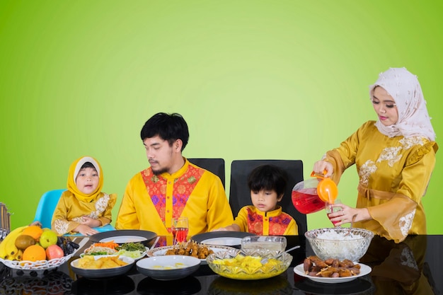 Asian woman pouring syrup for her family