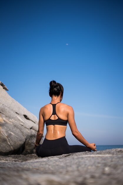 Asian woman practice yoga on the beach