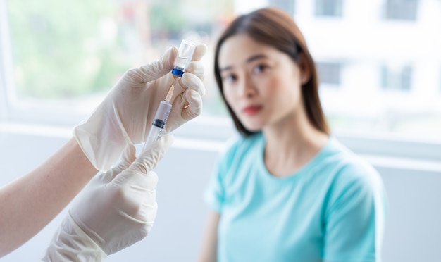 Asian woman preparing to be vaccinated