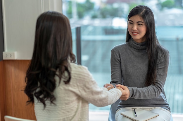 Asian woman professional psychologist doctor giving the consult to female patients