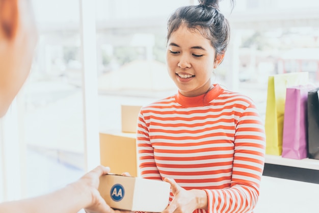 Asian woman receiving delivery package