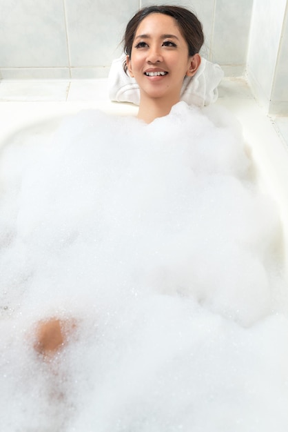 Asian woman relaxing on the bathtub