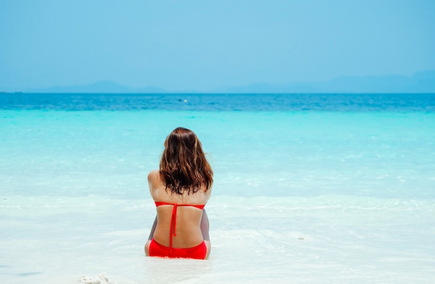 Asian woman relaxing on the beach as her vacation.