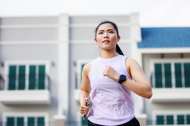 Asian woman running in the city