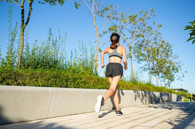 Asian Woman running in a park