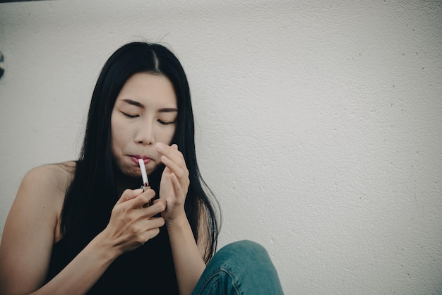 Asian woman sad from loveShe smoking because stress from boyfriendHeartbreak woman concept