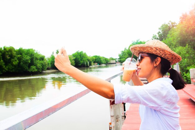 Asian woman selfie with glass of ice coffee, Travel and Lifestyle