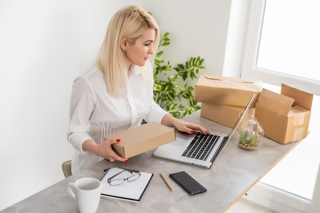 Asian woman selling business online marketing, woman with laptop and boxes