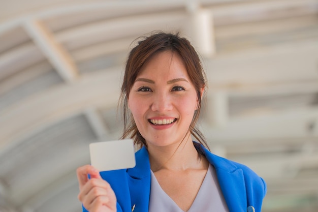 Asian woman showing credit card Online payment and shopping concept