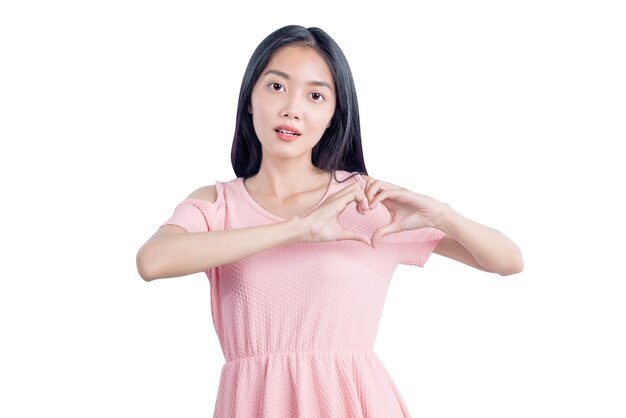 Asian woman showing heart shape with hands isolated over white background