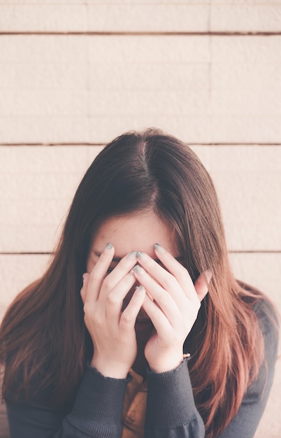 Asian woman sitting alone and depressed,stop abusing domestic violence, health anxiety,people bad frustrated exhausted feeling down