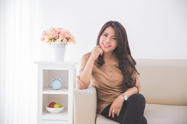 Asian woman sitting on the couch