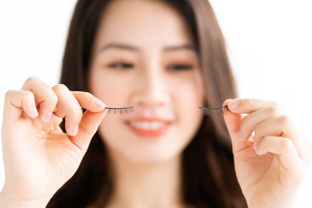 Asian woman sitting makeup in front of mirror