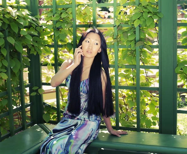 Asian woman sitting on the park bench