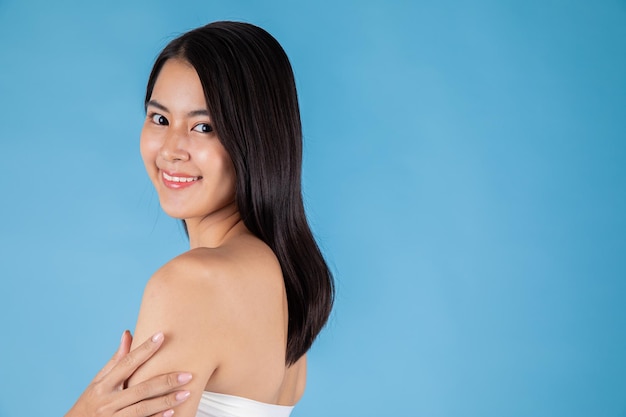 Asian woman Smiling skin portrait. Beautiful happy girl model with fresh glowing hydrated facial.